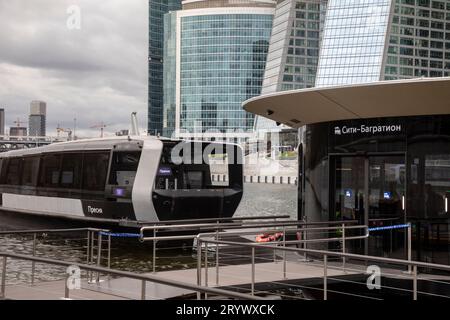 Moscow, Russia. 1st of October, 2023. The Presnya all-weather electric water bus docks at a pier near the skyscrapers of the Moscow City business center following the Kiyevsky - Heart of Moscow route, Russia. The first all-season regular Moskva River electric transport route was launched at the North River Terminal on June 20 Stock Photo