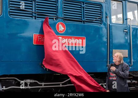 Rick Wakeman unveiling the name Radio Caroline on a vintage diesel at Mangapps Railway Museum near Burnham on Crouch, Essex, UK. Stock Photo