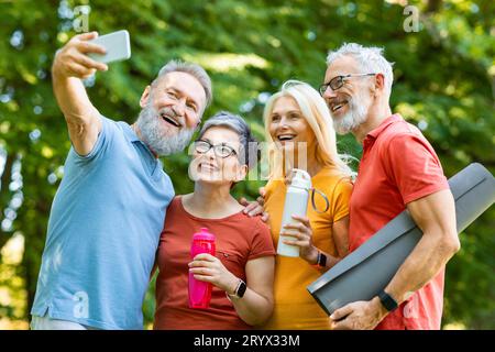 Group Of Sporty Senior People Taking Selfie Photo After Training Outdoors Stock Photo