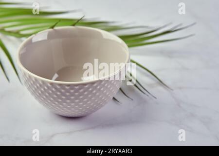 Modern trendy bowl on marble background. Minimalistic composition with tableware. Stock Photo