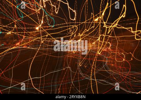 3D rendering of abstract light painting in the style of fireflies in yellow, red, green, and orange Stock Photo