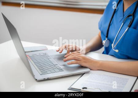 Medical technology network team meeting concept. doctor hands typing on keyboard laptop computerÂ Stock Photo