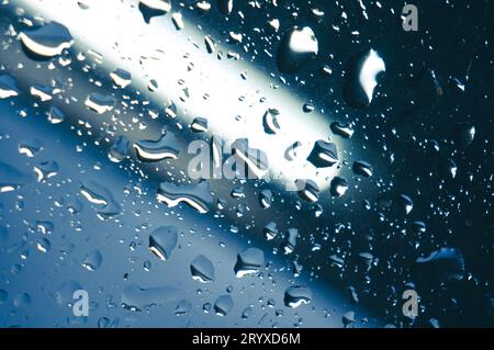 Rain drops on window glasses surface with sunset. drops on glass spray on window background for dark textÂ view selective focus Stock Photo