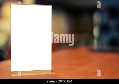 Mock up Menu frame standing on wood table in Bar restaurant cafe. space for text Stock Photo