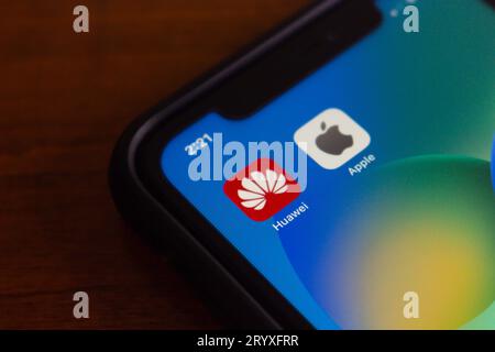 Vancouver, CANADA - Sep 27 2023 : Icons of Huawei and Apple seen in iPhone screen. Two big companies in smartphone and technology industry concept Stock Photo