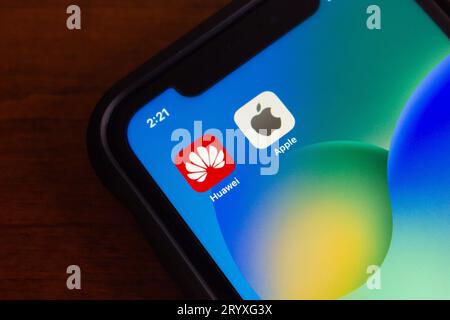 Vancouver, CANADA - Sep 27 2023 : Icons of Huawei and Apple seen in iPhone screen. Two big companies in smartphone and technology industry concept Stock Photo