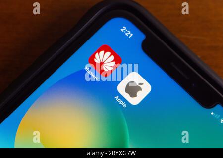 Vancouver, CANADA - Sep 27 2023 : Icons of Huawei and Apple seen in iPhone screen. Two big companies in smartphone and technology industry concept Stock Photo