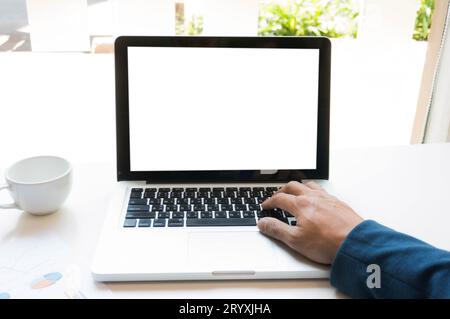 Man using, working on laptop with blank screen in meeting room. Stock Photo