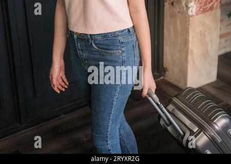 Woman guest at the reception of  hotel checking in. Stock Photo
