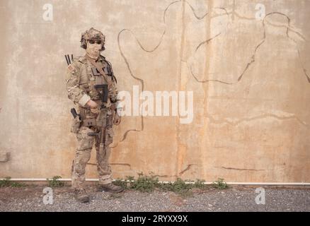 Special forces soldier in camouflage with a pair of weapons that are full of modern technology and complete for battle Stock Photo