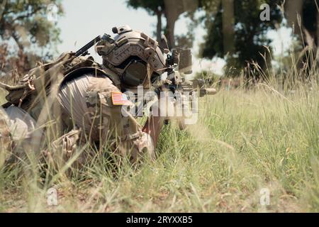 Special forces soldier in camouflage with a pair of weapons that are full of modern technology and complete for battle Stock Photo