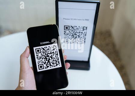 Qr code payment. E wallet. Man scanning tag accepted generate digital pay without money.scanning QR code online shopping cashles Stock Photo