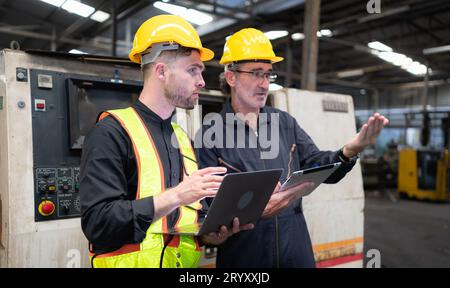 Engineers and technicians check the electrical system and repair the mechanical system in the control cabinet of the machine. in Stock Photo