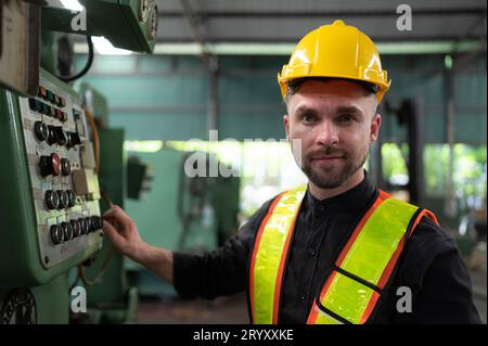 The engineer inspects the electrical system and repairs the mechanical system in the machine control cabinet. in order for the m Stock Photo