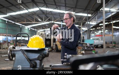 Senior engineer with fatigue from long and hard work Stock Photo