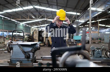 Senior engineer with fatigue from long and hard work Stock Photo