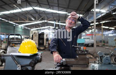 Senior engineer with fatigue from long and hard work Stock Photo