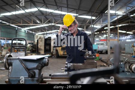 Senior engineer with fatigue from long and hard work Stock Photo