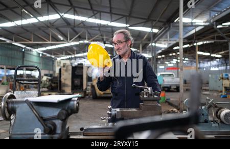 Senior engineer with fatigue from long and hard work Stock Photo
