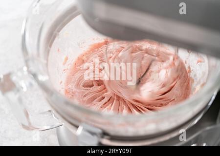 https://l450v.alamy.com/450v/2ryy09t/whipping-strawberry-buttercream-frosting-in-a-stand-alone-electric-mixer-with-a-whisk-attachment-2ryy09t.jpg