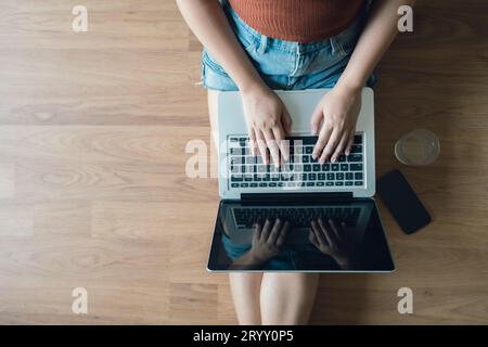 Woman Working by using laptop blank screen computer . Hands typing on a keyboard.technology e-commerce concept. Stock Photo