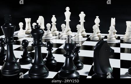 Black and white chess pieces on a chessboard background. Sport and leisure activity concept. 3D illustration rendering Stock Photo