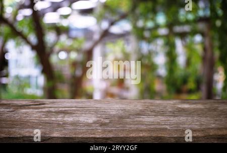 Image of wooden table in front of abstract blurred background of outdoor garden lights. can be used for display or montage your Stock Photo