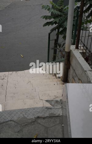 steps with iron railings, seen from above leading downwards. Stock Photo