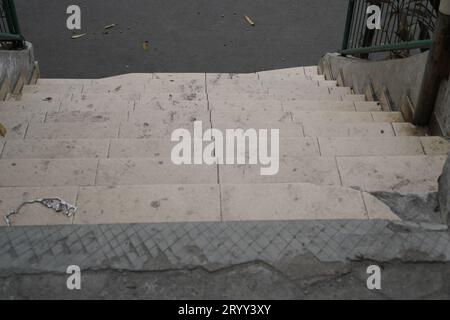steps with iron railings, seen from above leading downwards. Stock Photo