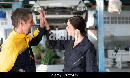 Portrait of engineer and auto mechanic with working on engine repairs in car garages Stock Photo