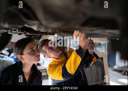 Engineers and auto repair technicians must use technology to detect faults in the operation of the engine of customer cars broug Stock Photo