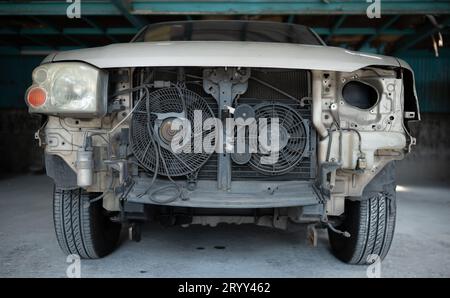 The engine of a car that has been hit hard. Professional technicians repair until it is in normal working condition. Stock Photo