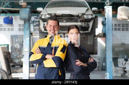 Portrait of engineer and auto mechanic with working on engine repairs in car garages Stock Photo