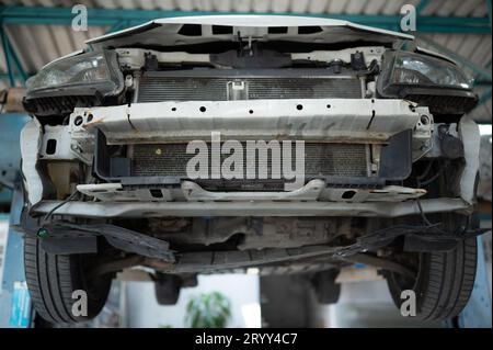 The engine of a car that has been hit hard. Professional technicians repair until it is in normal working condition. Stock Photo