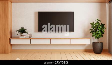 TV above wooden cabinet in modern empty room with plants carpet on wooden background. Japanese style theme. Architecture and int Stock Photo
