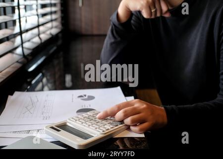 Businessman Accountant investment risk analysis. saving money for Stock market trading with calculator. Accountancy Stock Photo