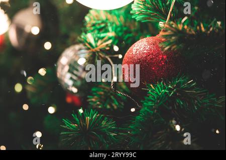 Closeup of decorate ornament on  Christmas tree with bokeh defocused light background. Holiday celebration and vacation. Merry x Stock Photo