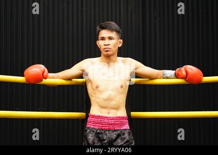 Muay Thai, The martial art of Thailand, Boxer sitting in the corner When the referee stops the fight in each round for the boxer Stock Photo