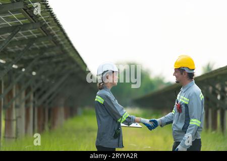At hundreds of acres of grass with solar panels A team of electric power engineers is testing a prototype of a small solar panel Stock Photo