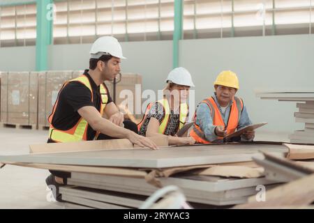 Meeting between designer and warehouse manager to organize the arrangement of product shelves in a huge, empty warehouse and inv Stock Photo