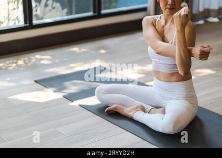 Flexible sport asian woman warming upÂ Fitness woman doing stretch exercise stretching exercising Fitness healthy relaxation Hom Stock Photo