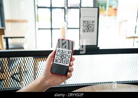 Qr code payment. E wallet. Man scanning tag accepted generate digital pay without money.scanning QR code online shopping cashles Stock Photo