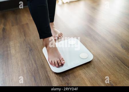 Bare feet standing on a scales. Lose weight concept with person on a scale  measuring kilograms. Weight Scale, Underweight man on Scale Stock Photo -  Alamy