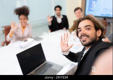 A diverse group of young business people taking selfies In the conference room of an international business company while waitin Stock Photo