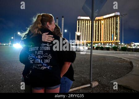 Las Vegas, Nevada, USA. 1st Oct, 2023. People comfort each other near the site of the 2017 Las Vegas mass shooting on October 1, 2023, in Las Vegas, Nevada. Approximately 150 people braved the unexpected rain and cold wind at the former Las Vegas Village to honor and remember the 58 people who were killed six years ago by a lone gunman during the Route 91 Harvest Music Festival from the 32nd story of Mandalay Bay Resort and Casino on October 1, 2017. Fifty-eight people died initially with two additional people dying later due to their injuries, making the incident is the deadliest mass shoot Stock Photo