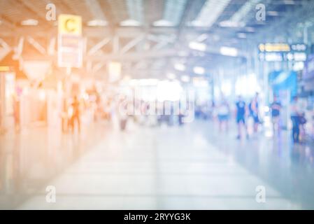 Blurry background of crowd people in airport. Business and Lifestyle concept. Blue and orange tone. Warm and Cool gradient light Stock Photo