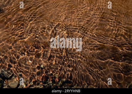Abstract blur of river rocks through flowing water Stock Photo