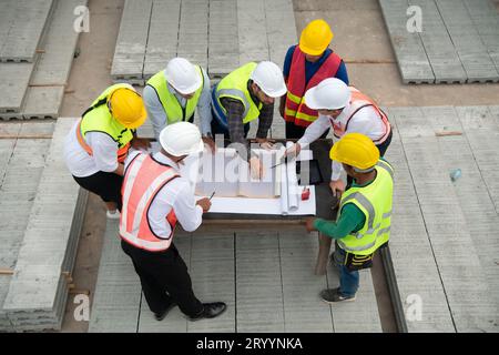 Construction engineers, architects, and foremen form a group. Participate in a meeting to plan new construction projects. Stock Photo