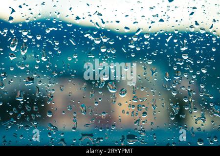 Rain drops on window glasses surface with sunset. drops on glass spray on window background for dark textÂ view selective focus Stock Photo