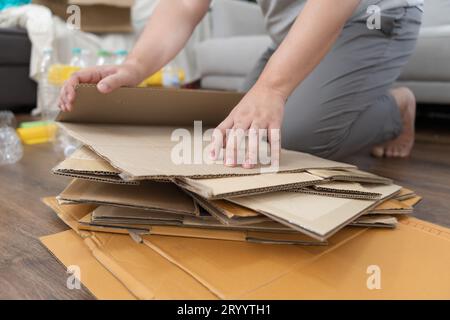 Home recycle eco zero waste concept Man using recycle paper box. Stacking brown cardboard box eco friendly packaging made of rec Stock Photo